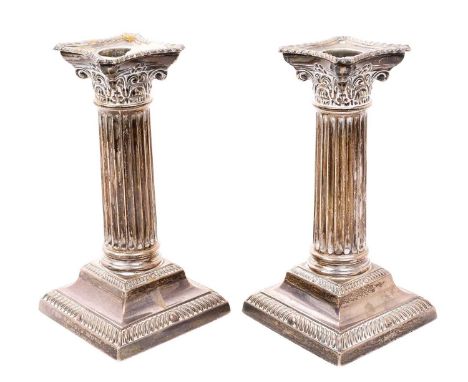 Pair George V silver Corithian column candlesticks, on square bases with gadrooned borders, separate sconces (Sheffield 1913)