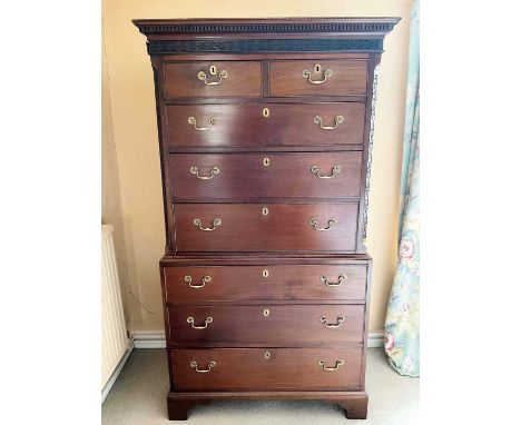 George III mahogany chest on chest with blind fret frieze and angles, having two short over six long graduated drawers, on br