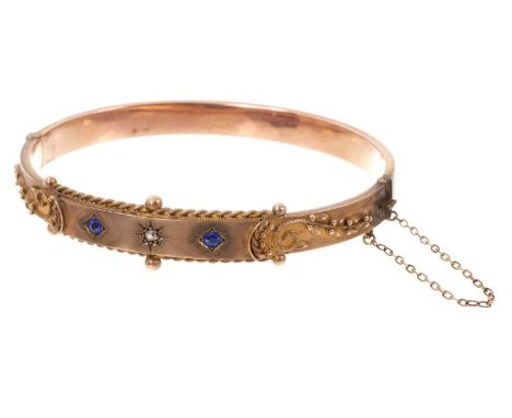 Edwardian 9ct rose gold diamond and synthetic sapphire hinged bangle with applied gold filigree decoration (Chester 1908)In v