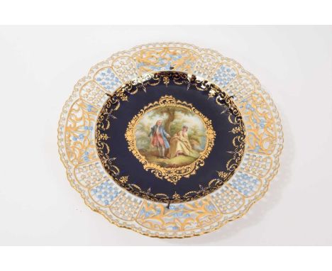 A Meissen porcelain dish, finely painted with a courting couple in a central panel within gilt scrollwork border, on a cobalt