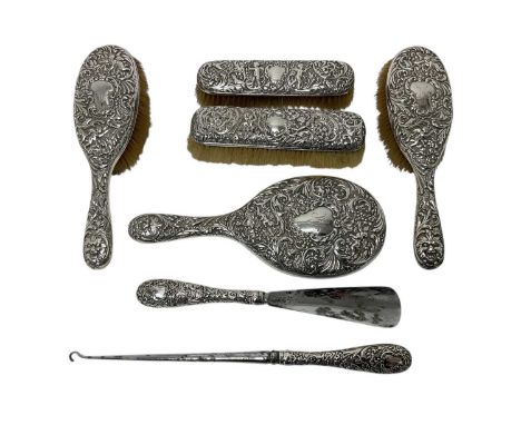 Selection of late Victorian, silver mounted dressing table items, with embossed foliate and figurative decoration, including 