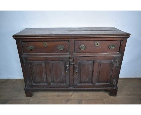 18th century oak dresser base, with two frieze drawers and fielded panel doors below on bracket feet, 130cm wide x 43cm deep 