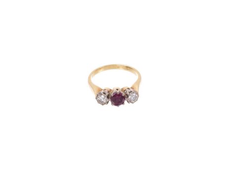 Diamond and ruby three stone ring with a central round mixed cut ruby flanked by two brilliant cut diamonds in 18ct yellow go