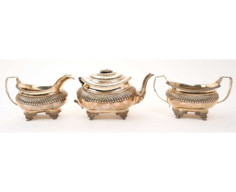 George III silver three piece tea set, comprising teapot of half fluted form, with gadrooned border, hinged cover (finial dam