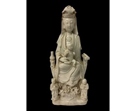 A Chinese blanc de chine porcelain figure of Guanyin and child, 19th/20th century, 38.5cm highSome restoration to front of he