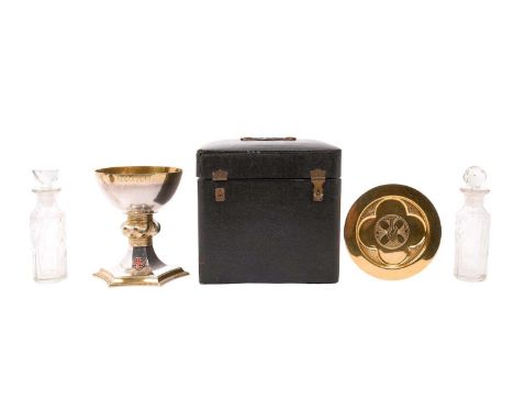 1930s Communion set, comprising silver parcel gilt chalice, with a pedestal stem, central knop and applied enamel emblem, on 