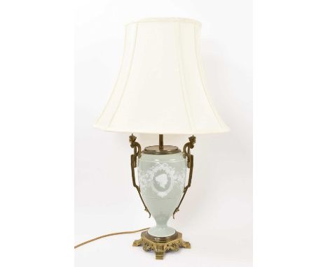 A 19th century pâte-sur-pâte porcelain table lamp, decorated with a portrait bust on a pale green ground, with ormolu mounts,