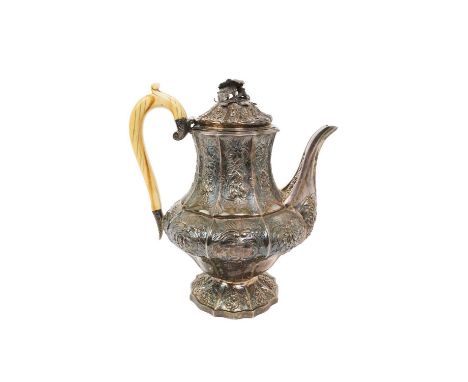George IV silver coffee pot of facetted baluster form, with embossed floral decoration, hinged cover and ivory handle, on a s