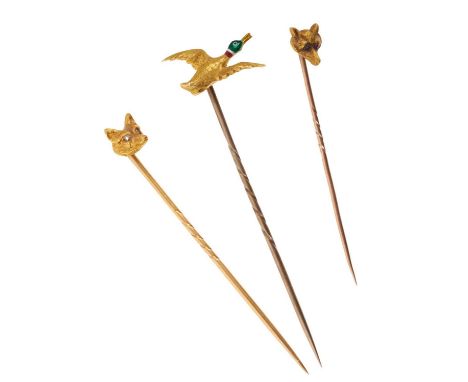 Two Victorian gold fox mask stick pins and an antique gold and enamel flying duck stick pin (3)