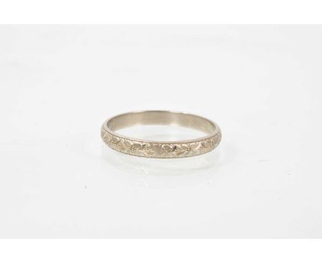 Platinum wedding ring with an engraved foliate band, Sheffield 1997, ring size V½.