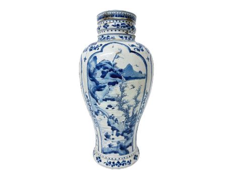 A large antique Chinese Qing period blue and white porcelain vase, painted with panels containing landscape scenes and flower