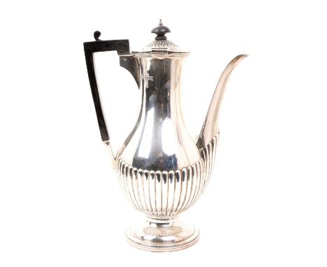 Edwardian silver coffee pot of baluster form, with half fluted decoration, hinged cover and angular ebony handle, on a circul
