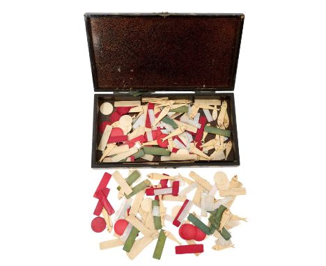 Collection of 19th century carved and stained bone playing counters, in abalone inlaid papier mâché box, 31cm long