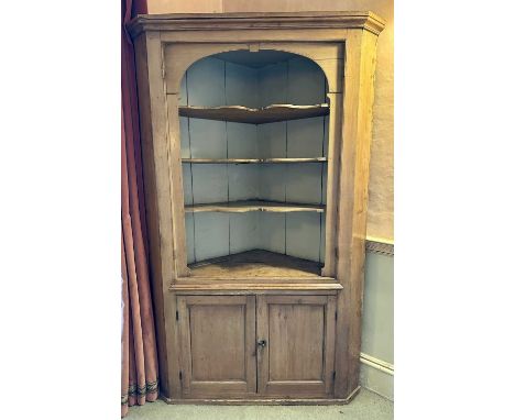 19th century pine corner cupboard, the three shaped shelves above twin cupboard door below, on plinth base, 115cm wide x 183c