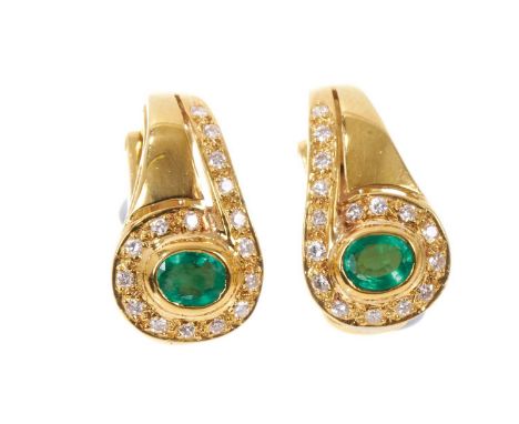 Pair of emerald and diamond earrings with an oval mixed cut emerald surrounded by a diamond set scroll in 18ct gold, 17.5mm.W