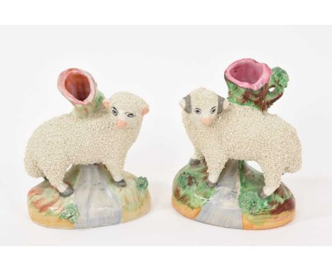 A pair of Staffordshire pottery small sheep spill vases, polychrome painted, 9cm high