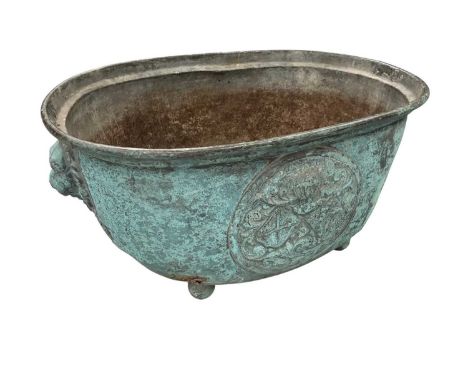 18th century Continental copper jardiniere, of oval bellied form, with armorial and flanking mask handles, on bun feet, 61cm 