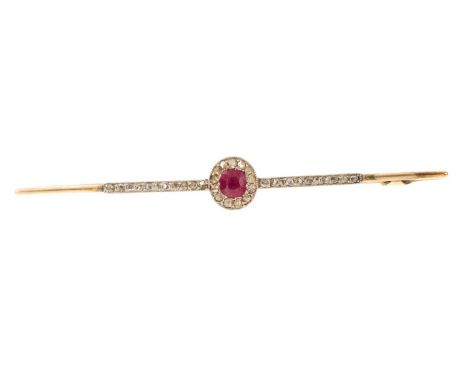 Edwardian ruby and diamond bar brooch with a central oval mixed cut ruby surrounded by rose cut diamonds in platinum and gold