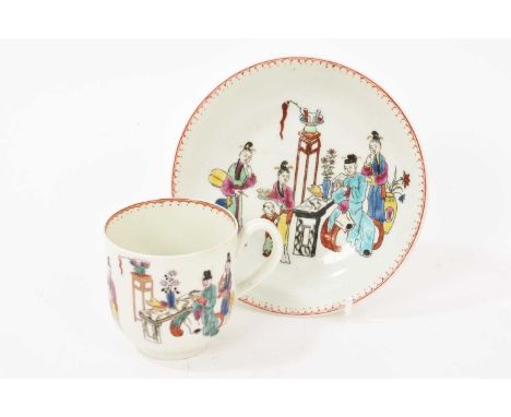 A Worcester cup and saucer, circa 1765, decorated in the 'Chinese Family' pattern, with patterned rims, the saucer 12cm diame