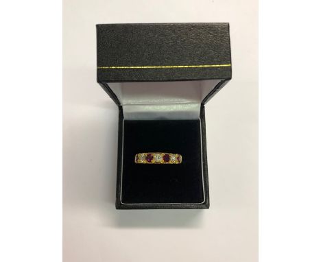 A seven stone ruby and diamond ring, yellow metal set stamped 18ct, 5.4g, size P/QShank distorted