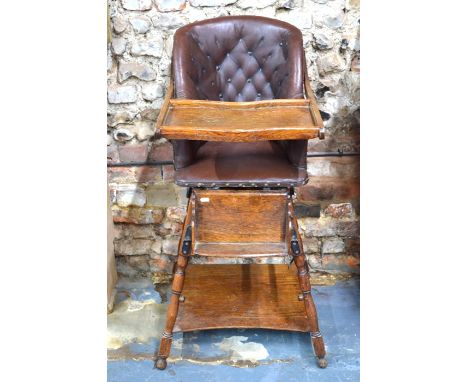 An antique metamorphic brown leather button child's high chair on an oak frame