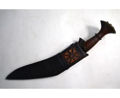 A Nepalese Gurkha kukri with brass-mounted wood handle and 26 cm engraved blade and leather scabbard