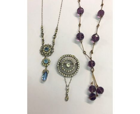 An Arts and Crafts style necklace, the yellow metal long links interspersed with facetted amethyst beads and three drops; a p