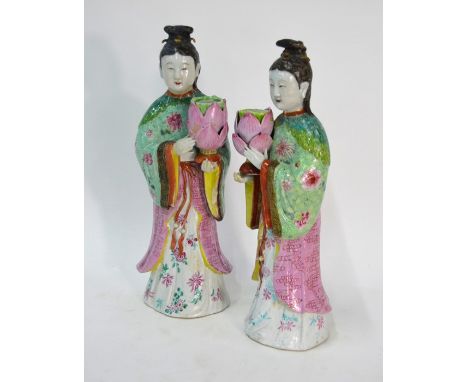 An elegant pair of famille rose figures; each one designed as a high ranking Manchu/Chinese lady wearing black hair in an ela