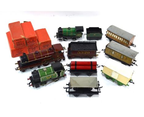 An extensive collection of Hornby O'gauge clockwork railway locomotives, rolling stock, track and accessories, some boxed, in