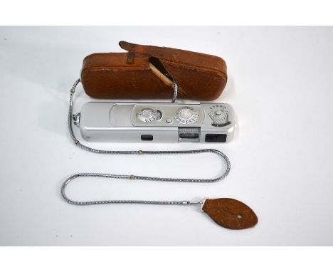 A Minox BL pocket camera with Complan 1:3,5 f=15mm lens, in leather case with guard chain