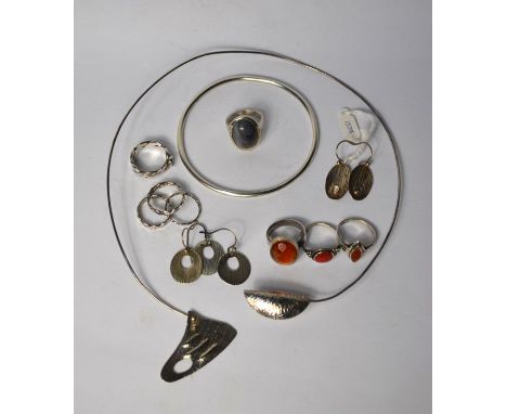 A collection of various contemporary silver and white metal jewellery items including a torque with folded hammered centrepie