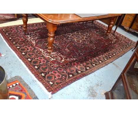 A Turkish carpet, the centre medallion design on brown-red ground, 305 cm x 205 cm