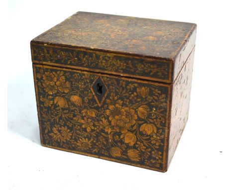 An early 19th century pen-work tea caddy of cuboid form, richly decorated with floral and foliate designs, 13 cm wide