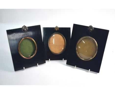 Three ebonised frames for portrait miniatures, with acorn and leaf mounts (empty)