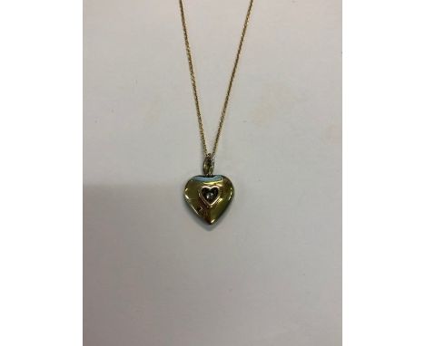 A pave-set diamond heart shaped pendant on diamond set hanger, the reverse with heart shaped open back revealing diamond, yel