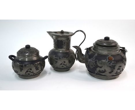 A Chinese pewter mounted service, comprising: teapot, sugar bowl and milk jug. the teapot marked on the base: Wen Hua Shun/18