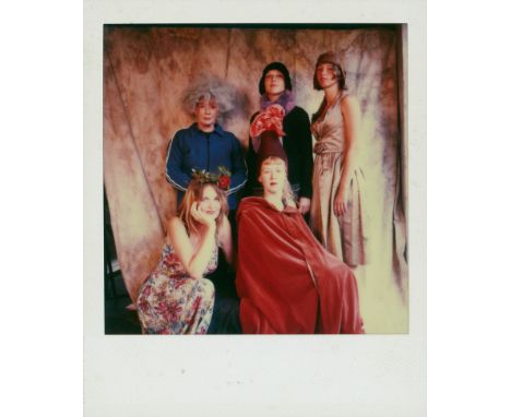 Bergemann, Sibylle -- Self-portrait with models. 1990s. Vintage polaroid photo. 9 x 11 cm.Some surface scratches, more visibl