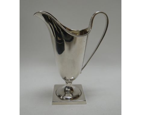 A CASED SILVER HELMET CREAM JUG, of plain form, London 1956, 3.1ozs