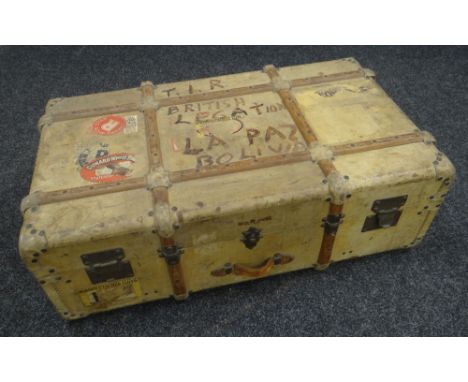 A MALLES COSMOPOLIS CABIN TRUNK with timber banding, leather carry handles and with numerous early twentieth century passenge