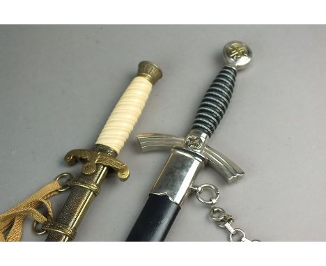 A replica of German Luftwaffe First Pattern dagger complete with scabbard and hanger, a further replica Nazi dagger with ivor