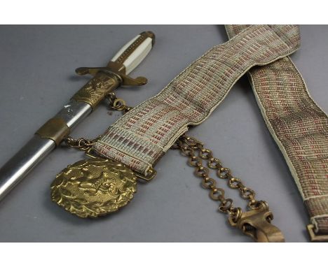 A Polish dress dagger, the swollen celluloid grip with brass inlay, blade length 24cm, overall length 33cm, scabbard with bra
