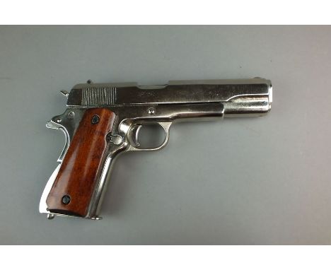 A Denix replica of a chrome US ARMY M1911 autoloading pistol, .45 calibre, with removable magazine, moving trigger, hammer an