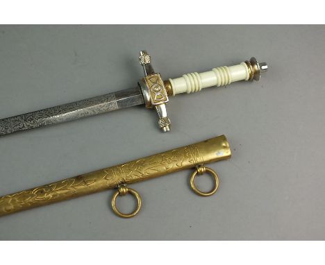 A Naval dagger and brass engraved scabbard, with turned white composition grip, anchor to the hilt, the etched blade by E.A. 