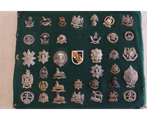 A collection of 67 Army badges on two felt covered cardboard display boards