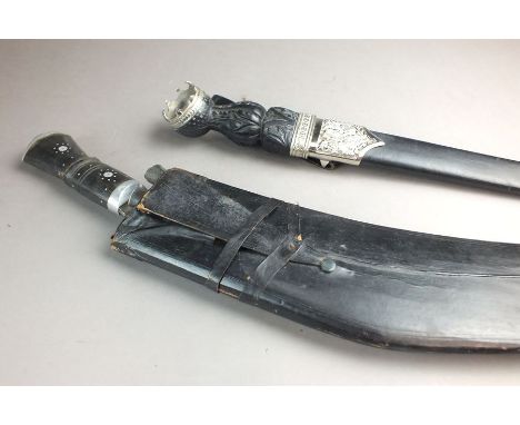 A Second World War kukri contaied within black leather scabbard, together with a dirk, the blade marked 'Glasglow, Scotland' 