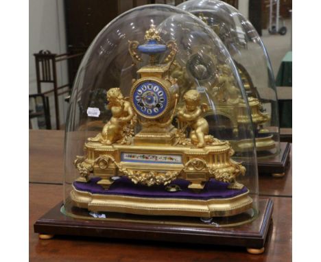 A Gilt Metal and Porcelain Mounted Striking Mantel Clock, circa 1890, surmounted by an urn finial, flanked by winged cherubs,