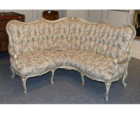 A 19th Century White Painted and Parcel Gilt Corner Sofa, in Louis XV style, recovered in cream, blue, pink and floral button