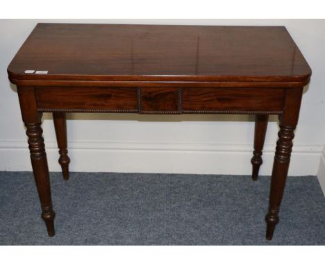 A Victorian Mahogany Foldover Tea Table, 2nd quarter 19th century, with a gadrooned frieze, raised on ring turned tapering le