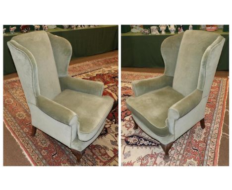 A Pair of Early 20th Century Wing-Back Chairs, in George III style, later recovered in green velvet, with rounded arm support