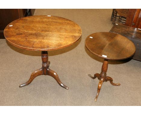 A George III Oak Fliptop Circular Tripod Table, late 18th century, raised on a baluster turned support with three cabriole le